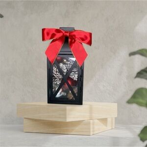 Black Lantern with Red Bow and Pinecone Decor
